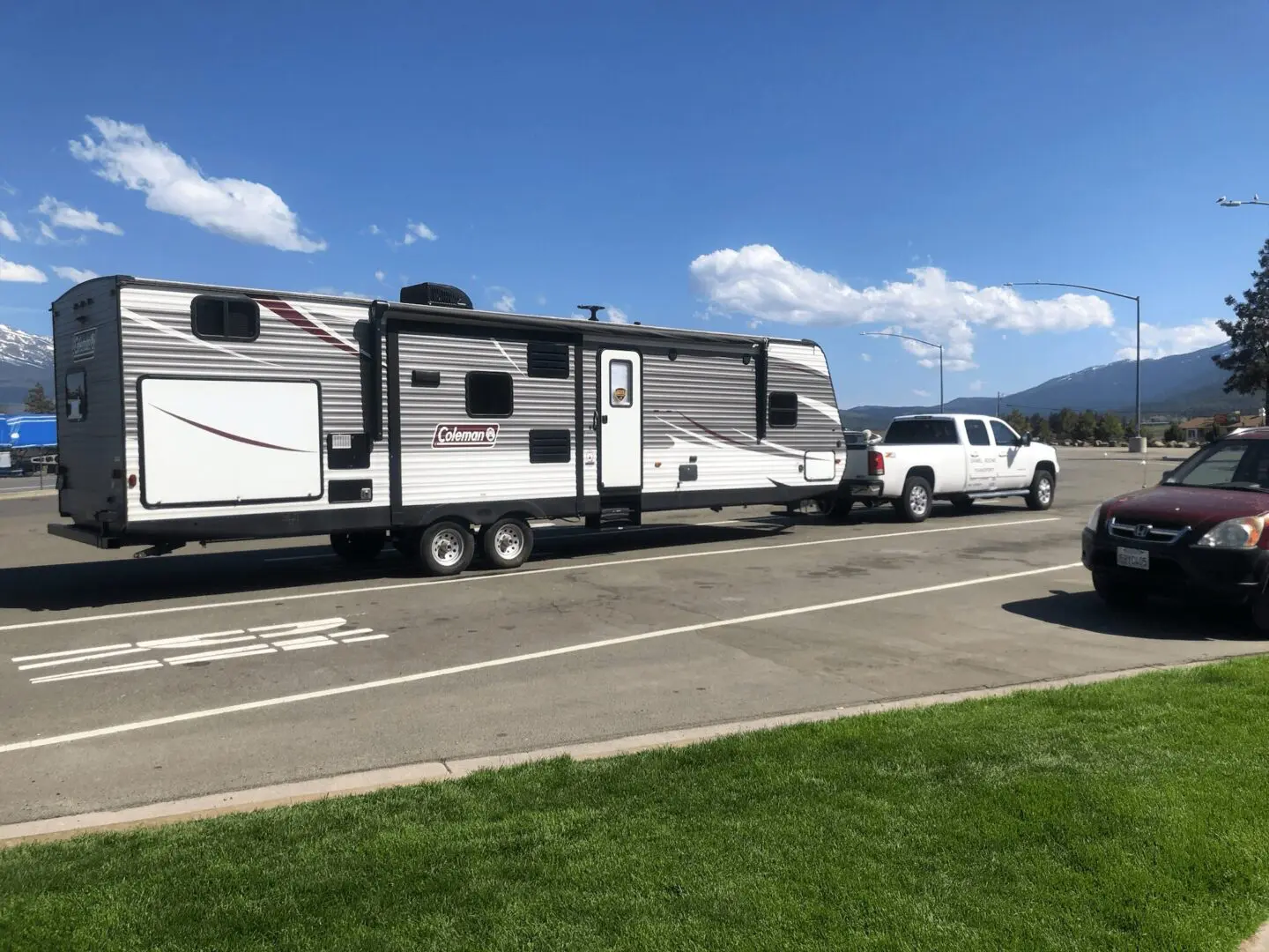 A truck and trailer on the side of the road.